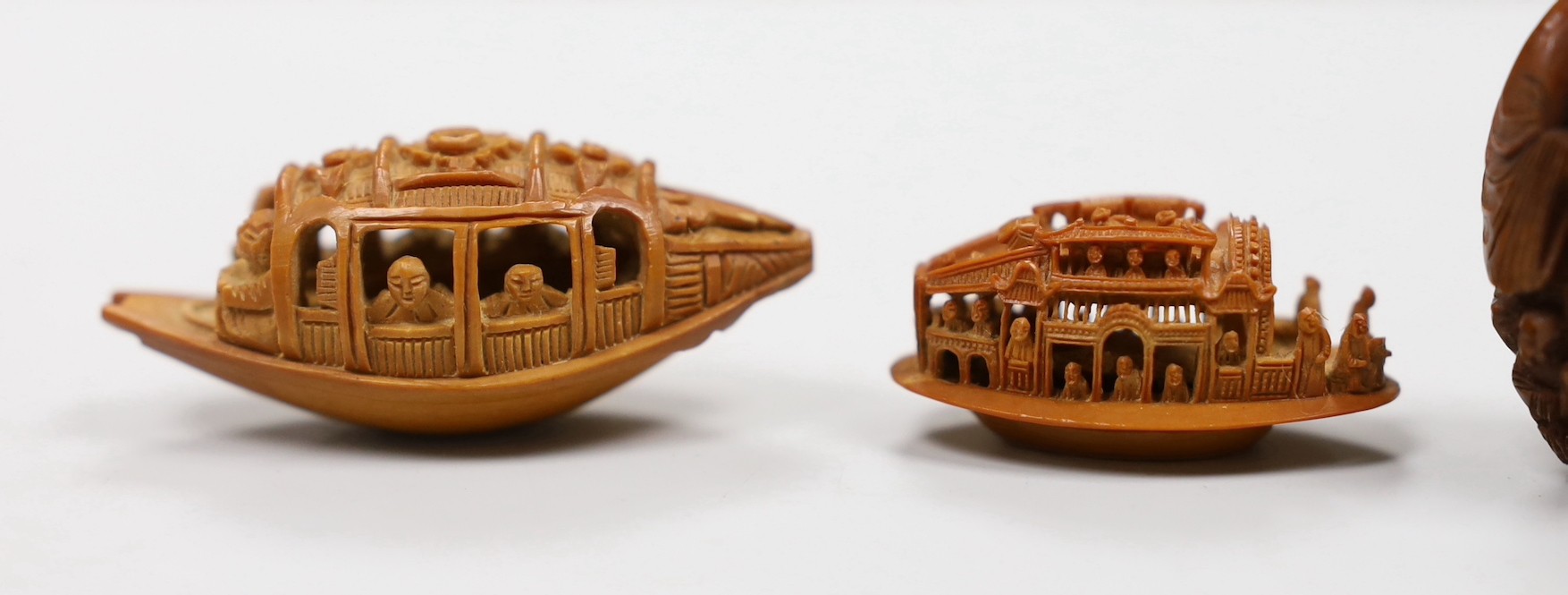 Five Chinese peach stone carvings, largest 4.2cm and a coquilla nut egg shaped box
